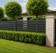 A modern fence enhancing the look of a property with neatly trimmed hedges and trees in the background.